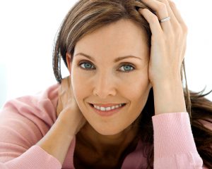 Middle aged brunette resting her head her in hands
