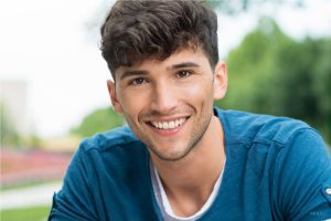 H2 line height tablet Young man in blue sweater with slight facial hair and dark hair
